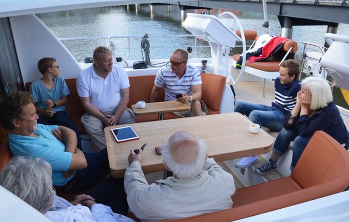 a group of people sitting around a table aboard MOJEKA  Yacht for Charter