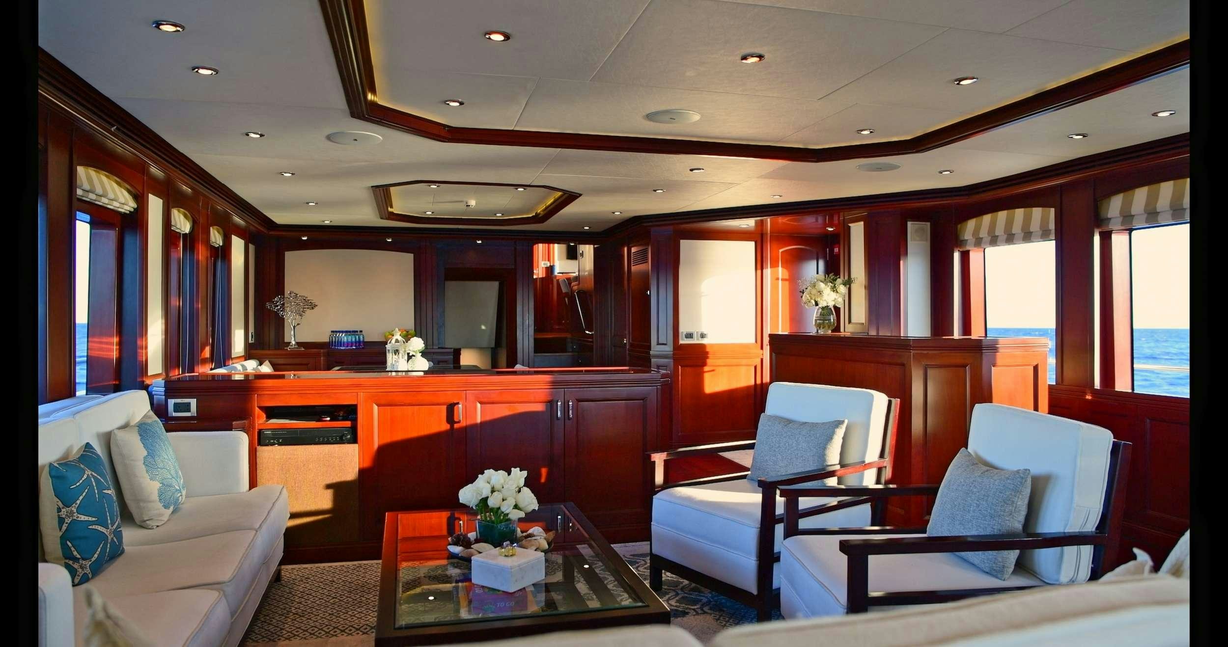 a living room with a couch and a coffee table aboard SAMSARA Yacht for Charter