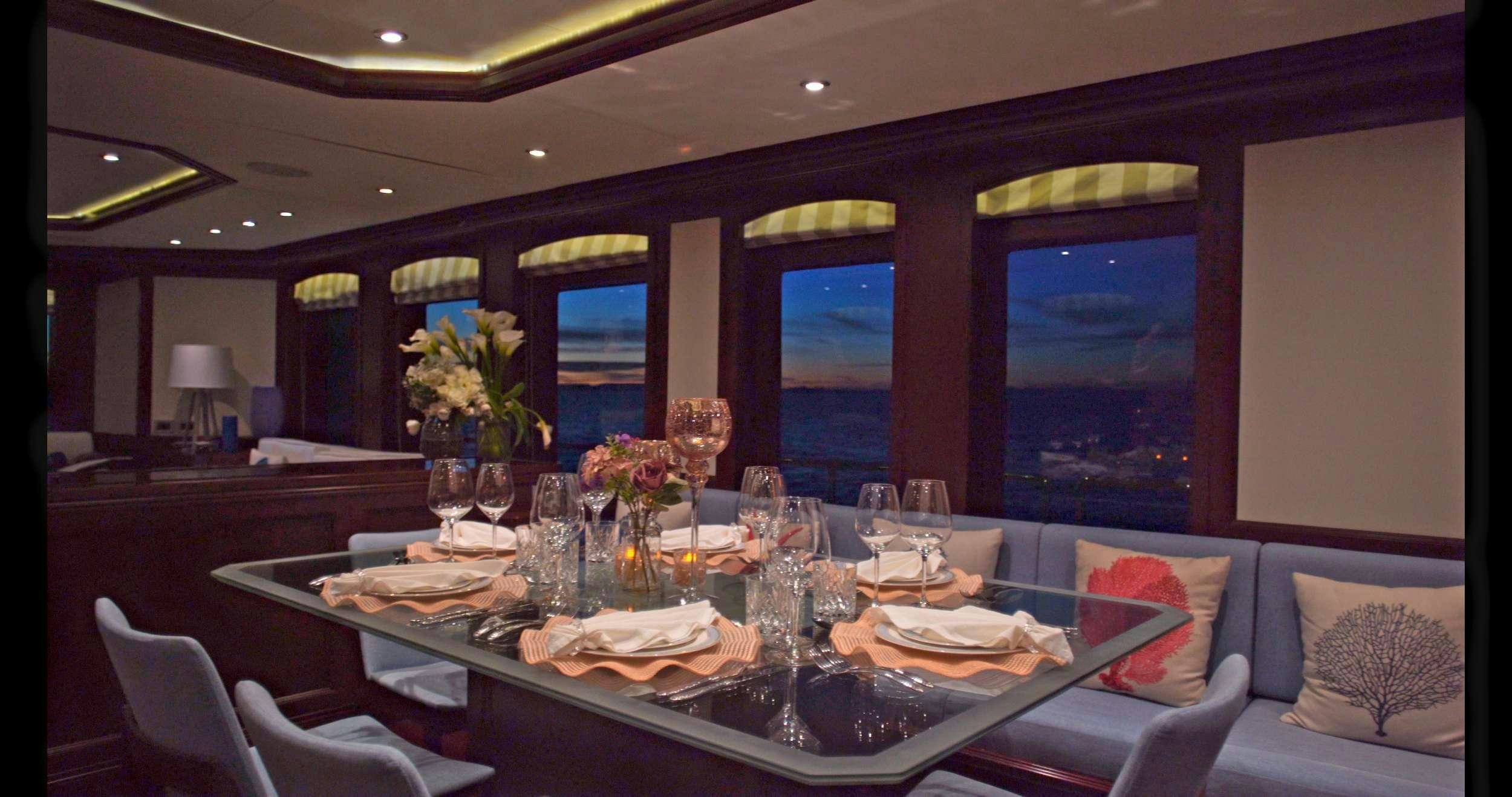 a table with wine glasses and food on it aboard SAMSARA Yacht for Charter