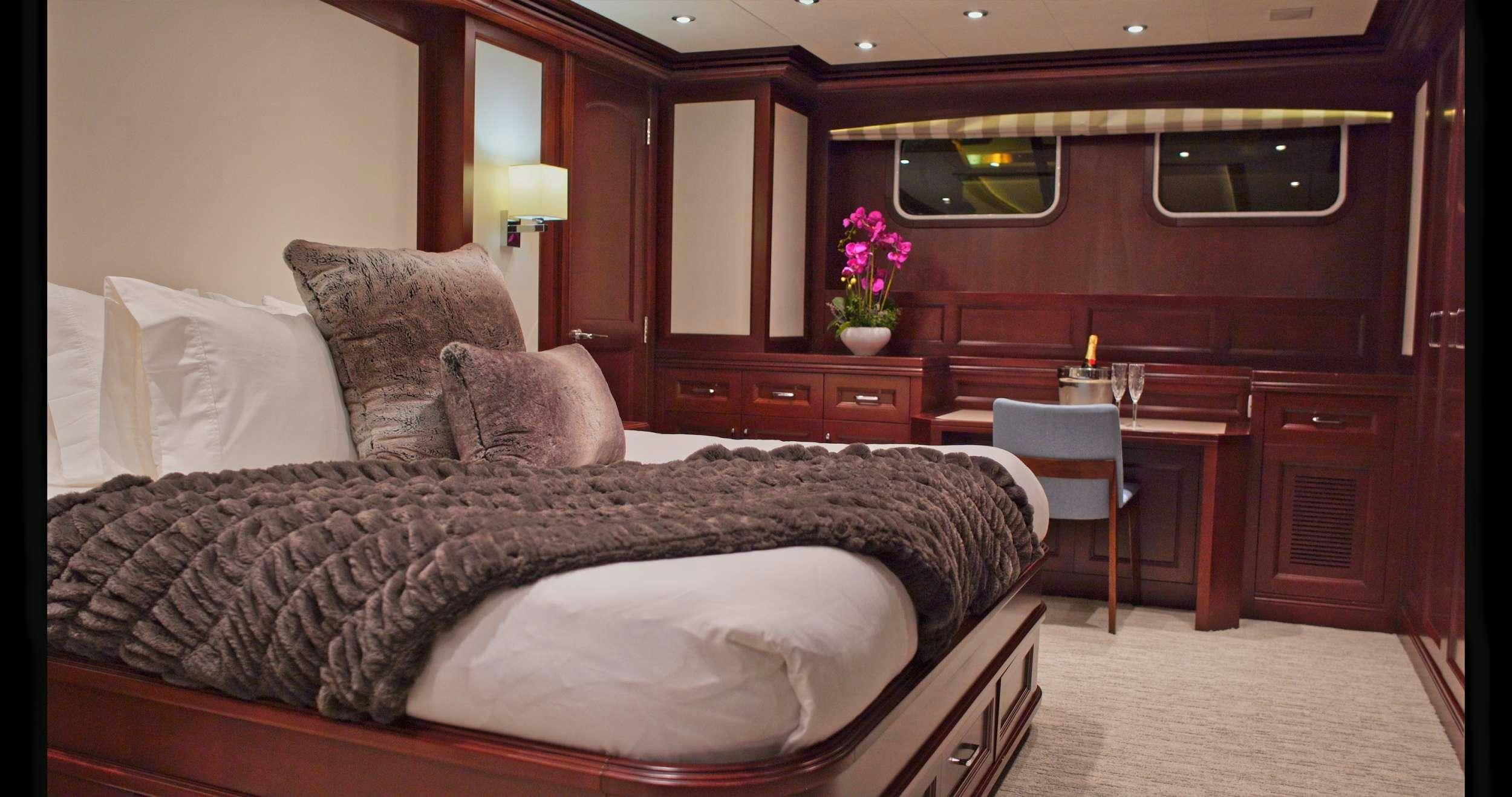 a bed with a black comforter aboard SAMSARA Yacht for Charter