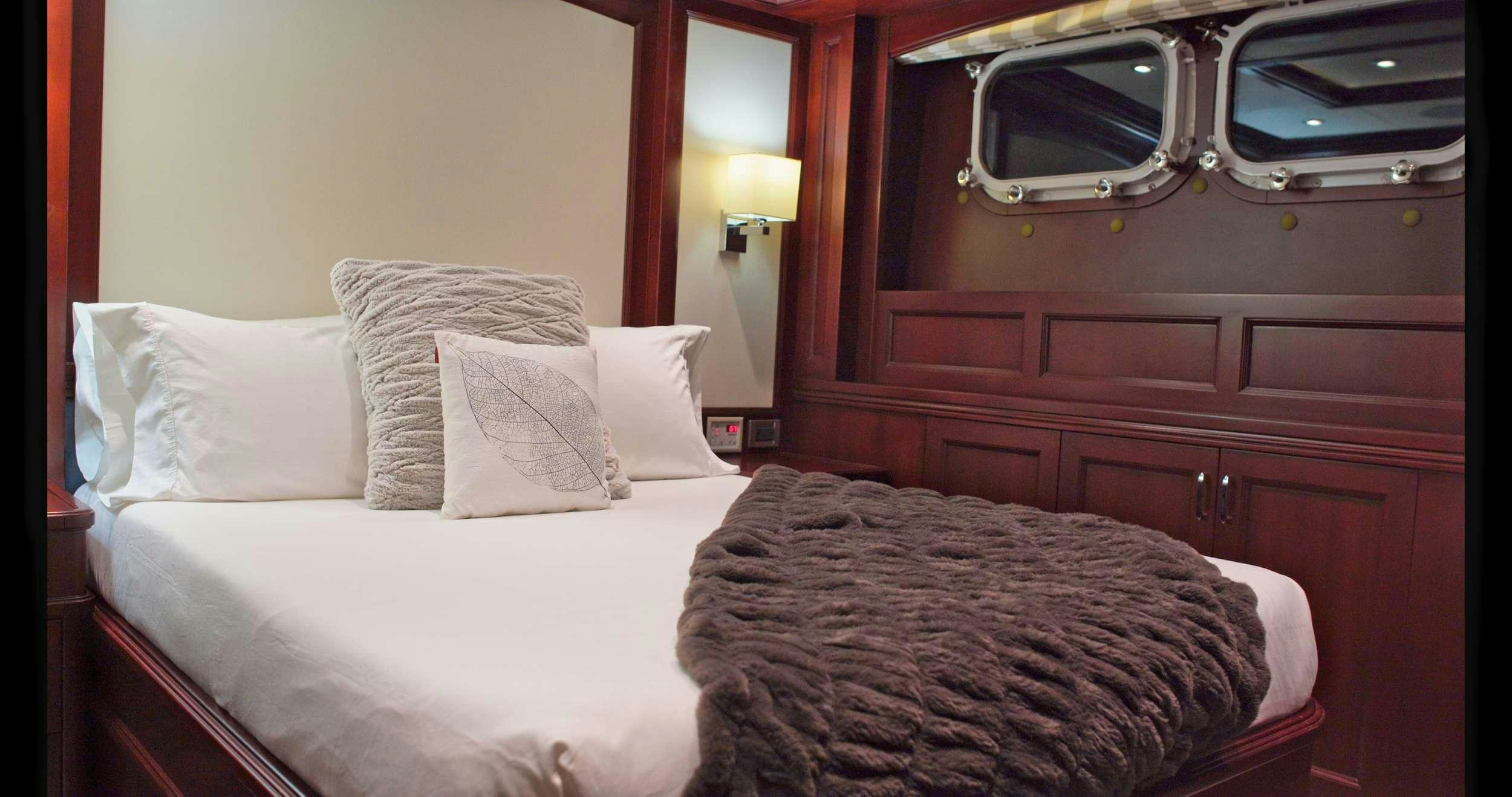 a bed with white pillows aboard SAMSARA Yacht for Charter