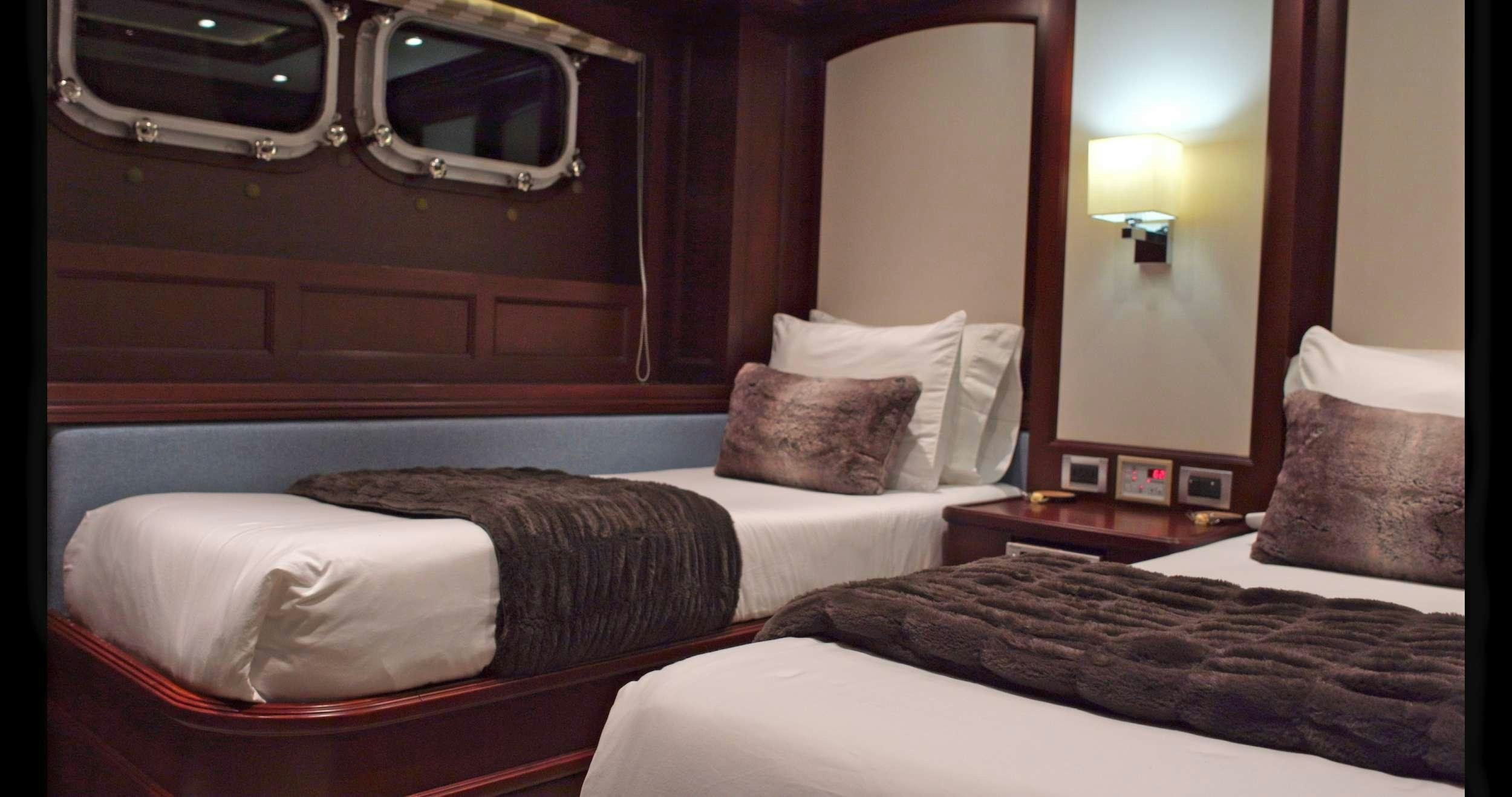 a couple of beds in a hotel room aboard SAMSARA Yacht for Charter