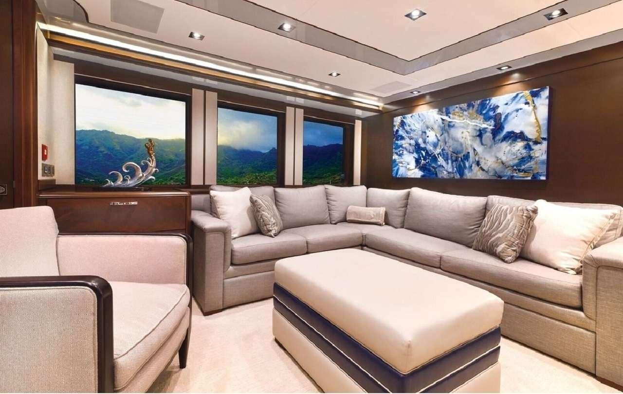 a living room with a couch and a tv aboard VIVIERAE II Yacht for Charter