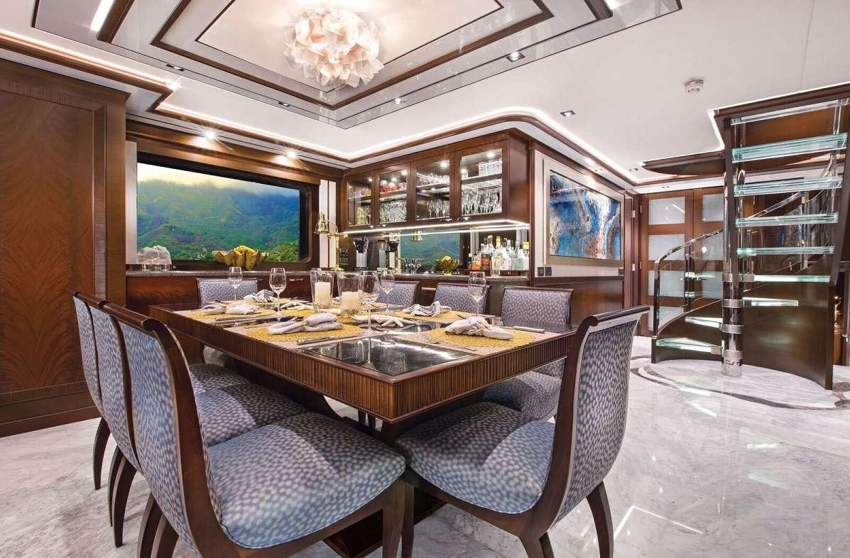 a large dining table in a room aboard VIVIERAE II Yacht for Charter