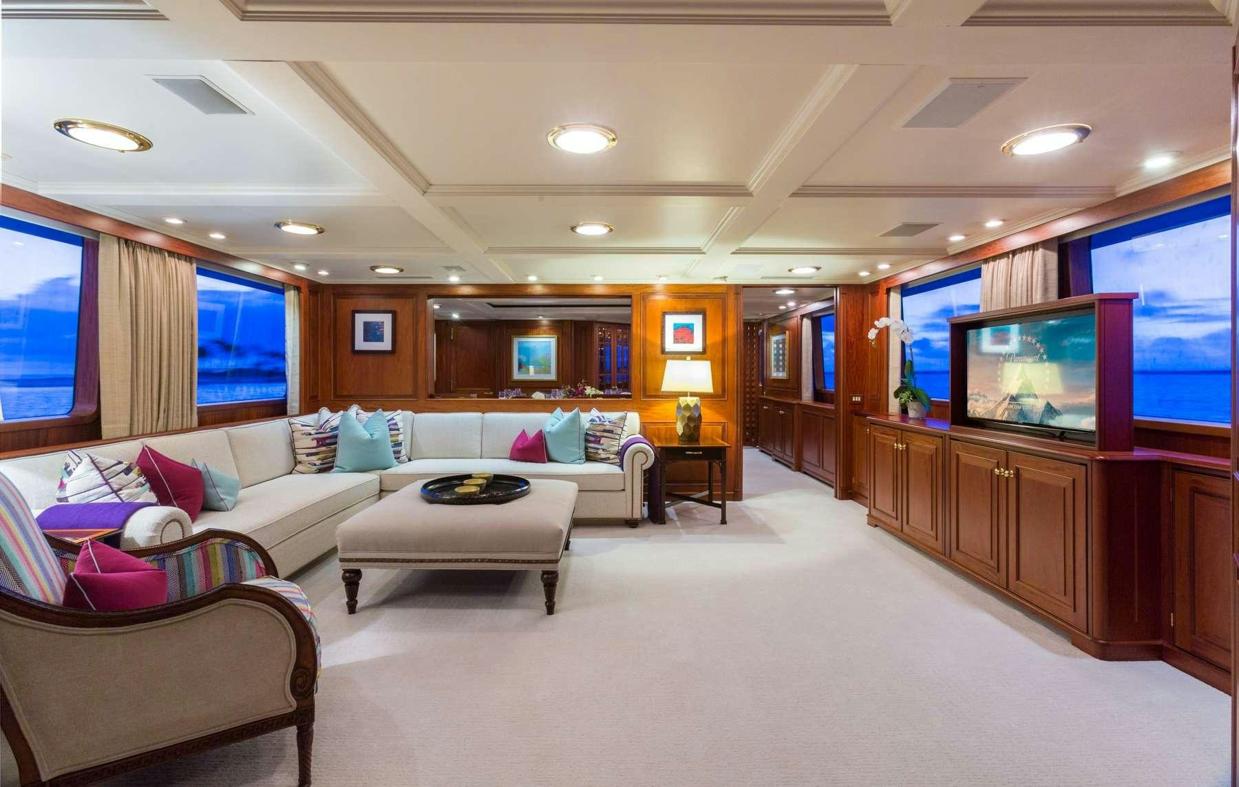a living room with a large screen aboard LADY J Yacht for Charter