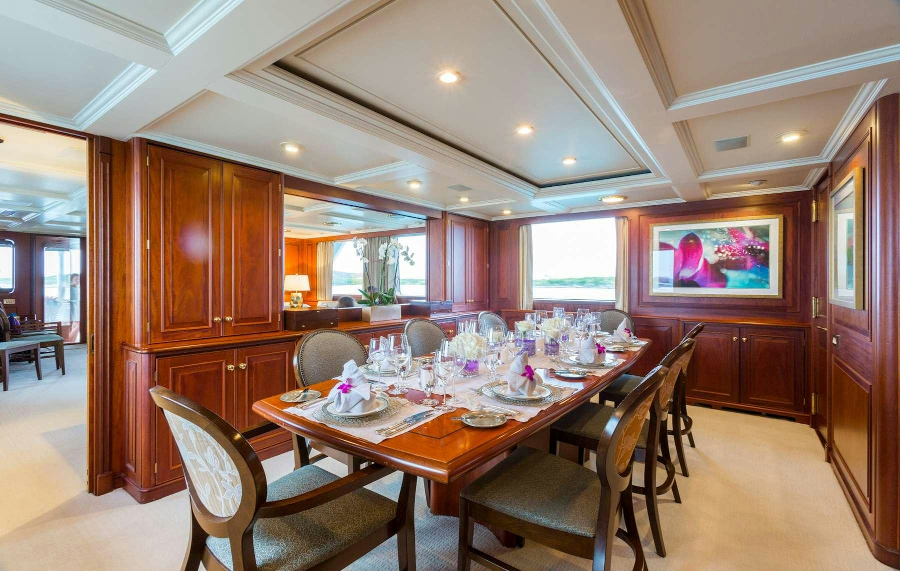 a dining room with a table and chairs aboard LADY J Yacht for Charter