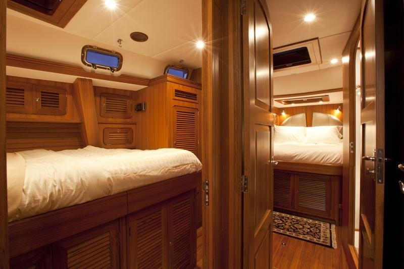 a room with a bed and a desk aboard ARCHANGEL Yacht for Charter