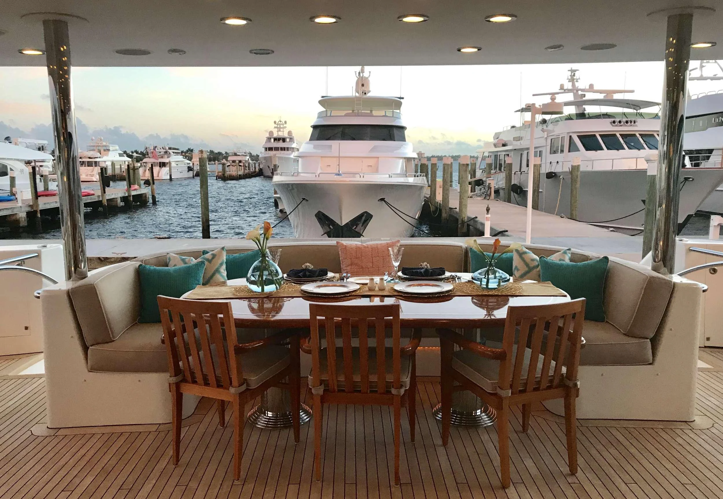 a table with chairs and a couch aboard RELENTLESS Yacht for Charter