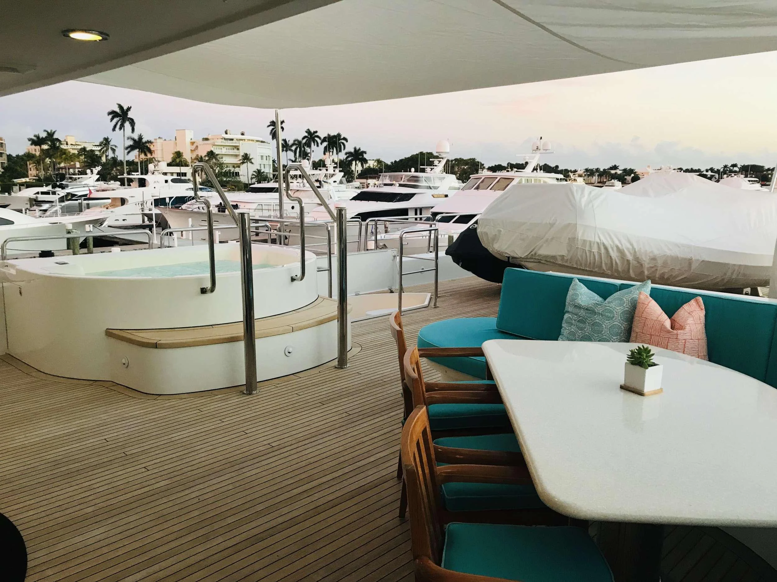 a lounge area with tables and chairs aboard RELENTLESS Yacht for Charter