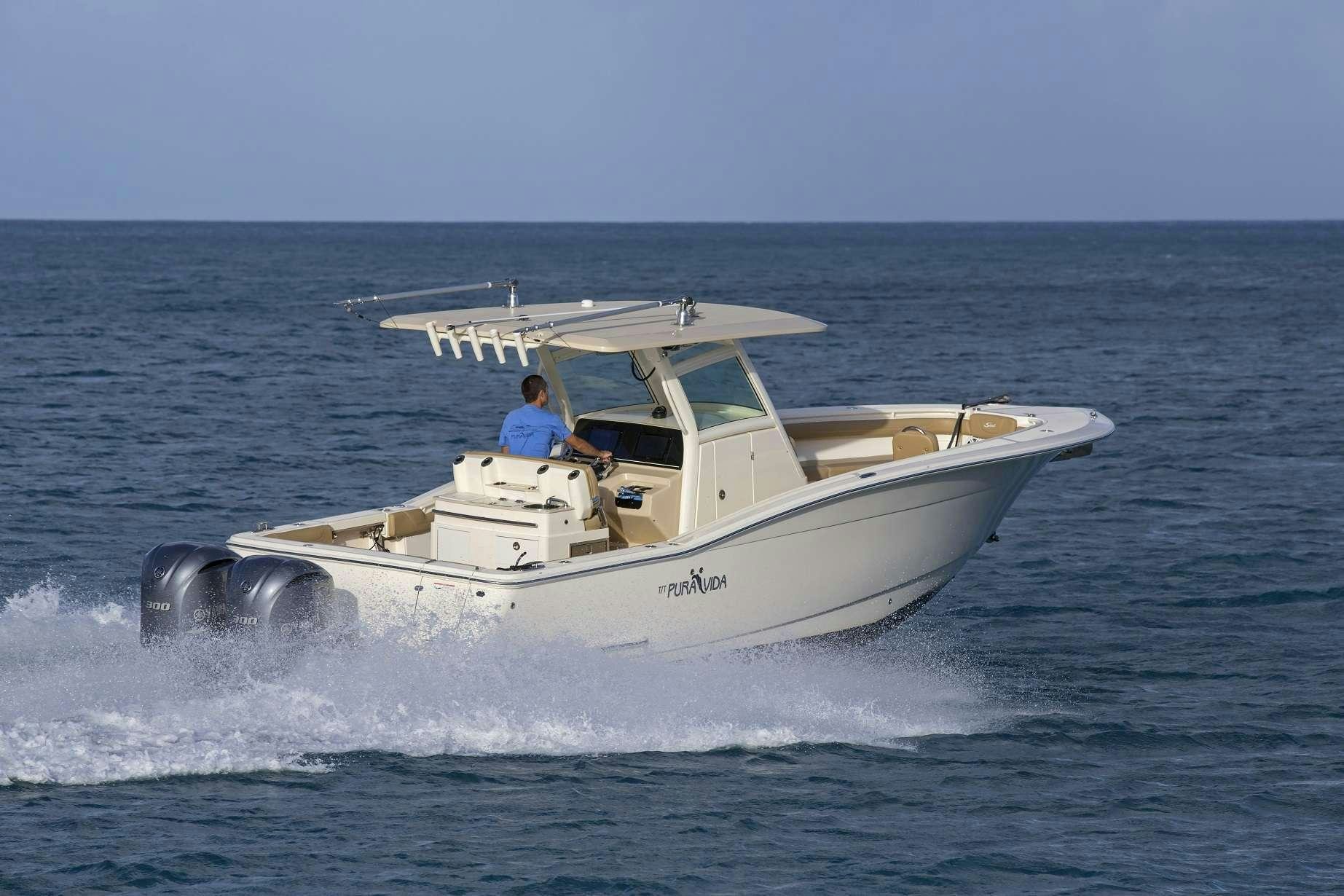 a person driving a boat aboard PURA VIDA Yacht for Charter