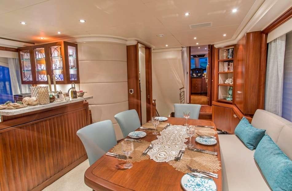 a kitchen with a dining table aboard PURA VIDA Yacht for Charter