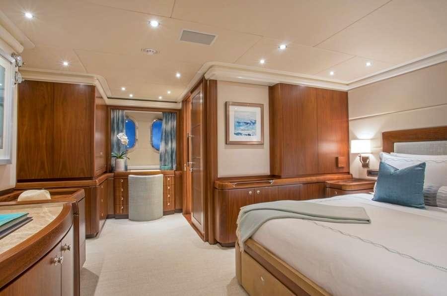a bedroom with a bed and a closet aboard PURA VIDA Yacht for Charter
