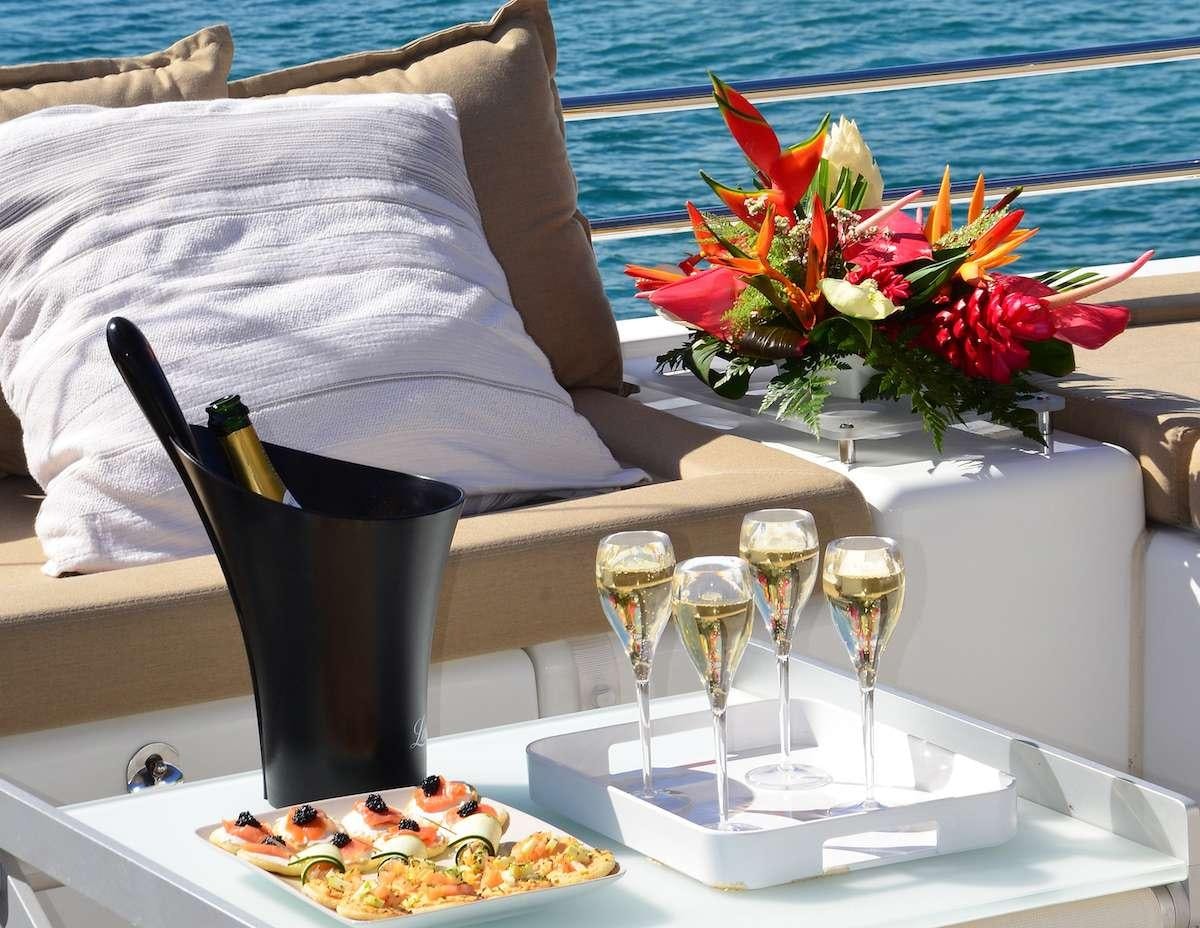 a table with food and drinks aboard BACCHUS Yacht for Charter