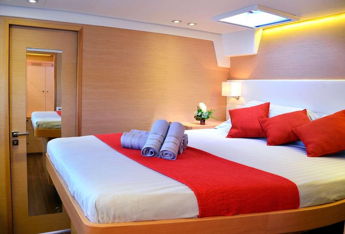 a couple of beds in a hotel room aboard BACCHUS Yacht for Charter