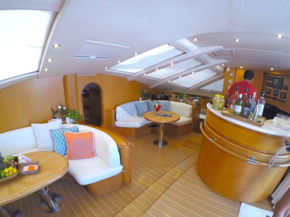 a room with a table and couches aboard KELEA Yacht for Charter