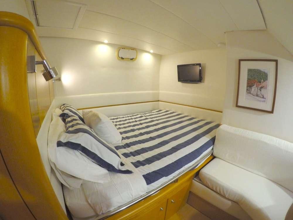 a small bedroom with two beds aboard KELEA Yacht for Charter