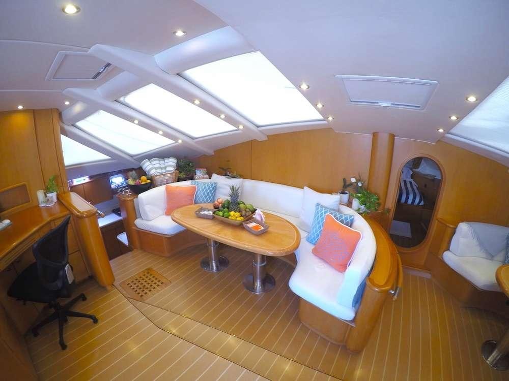 a room with a table chairs and a couch aboard KELEA Yacht for Charter