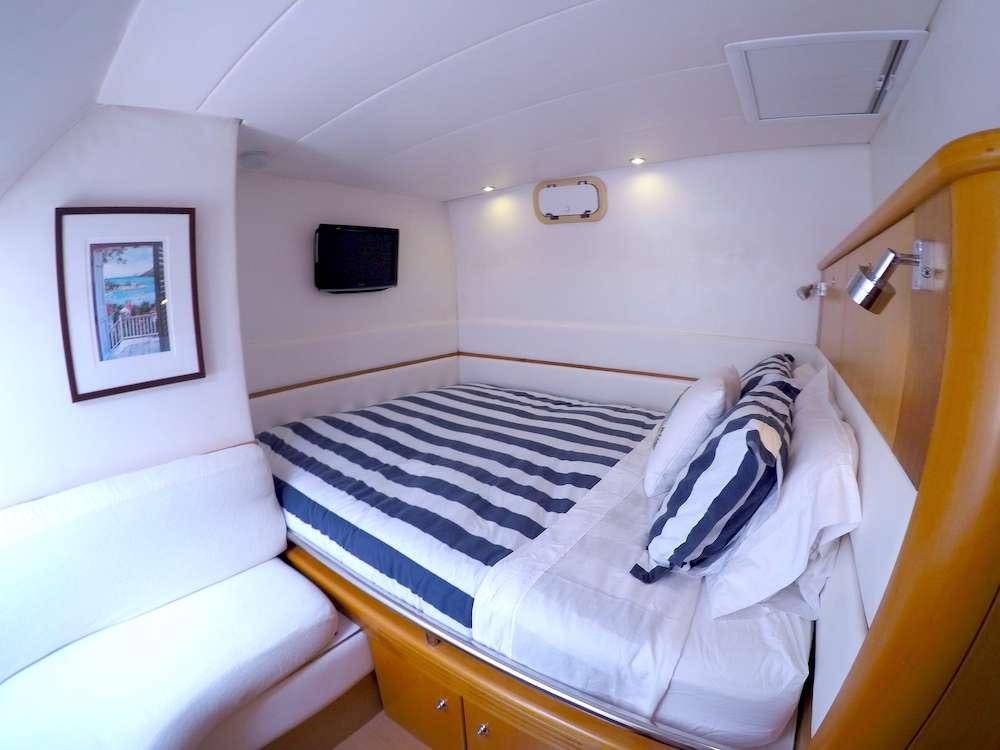 a small bedroom with a bed aboard KELEA Yacht for Charter