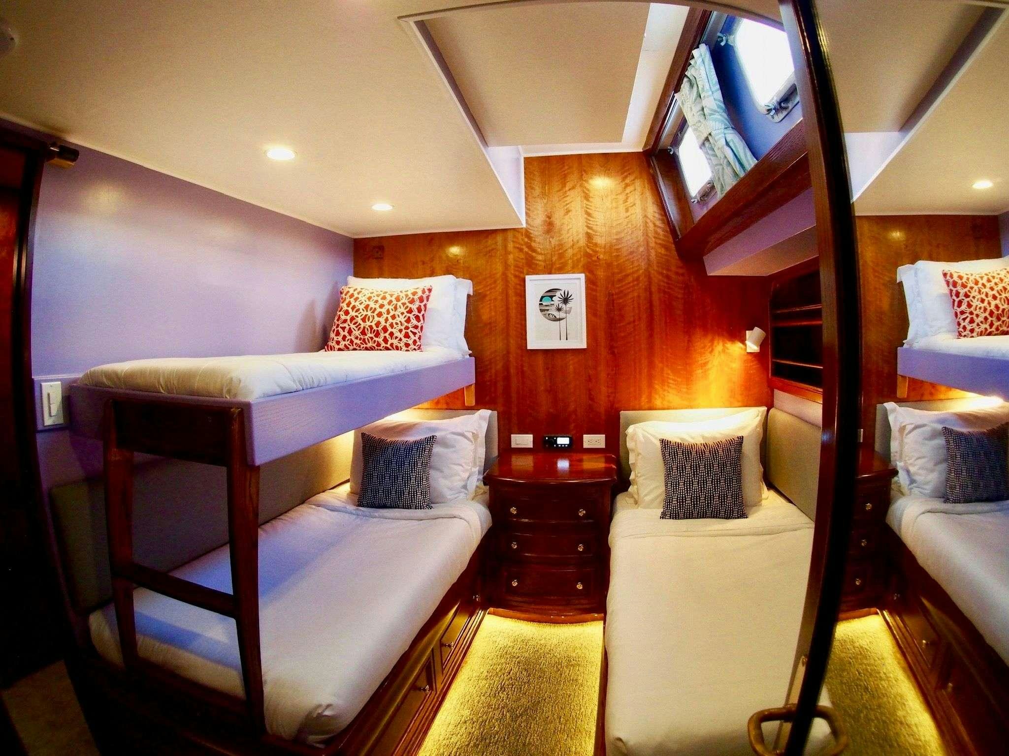 a room with a bed and a mirror aboard AUGUST MAVERICK Yacht for Charter