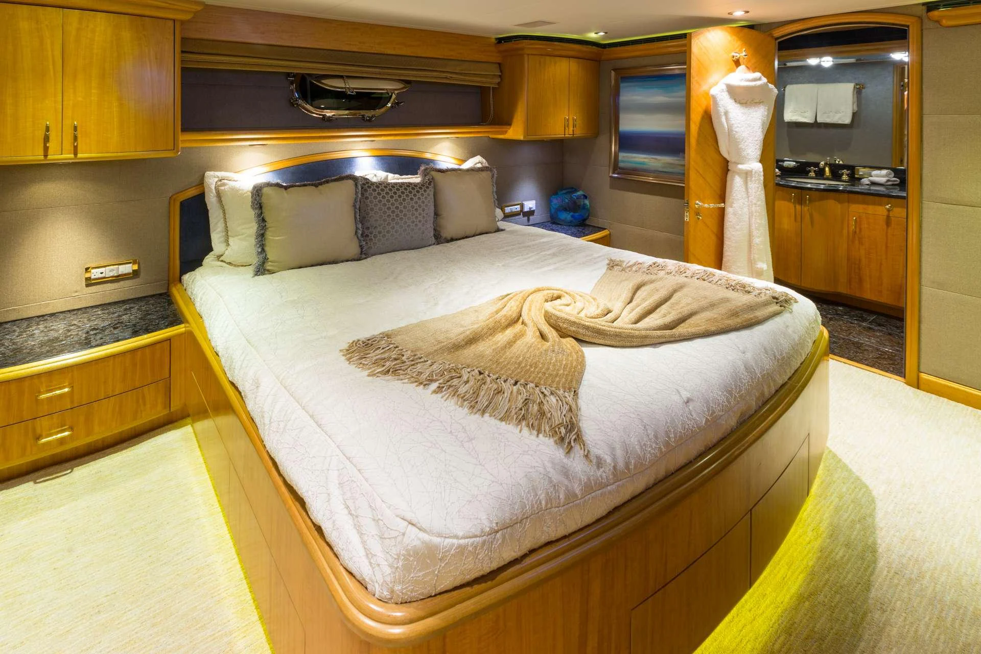 The master stateroom features a luxurious bed with plush pillows and elegant decor. aboard CHARLOTTE ANN Yacht for Charter