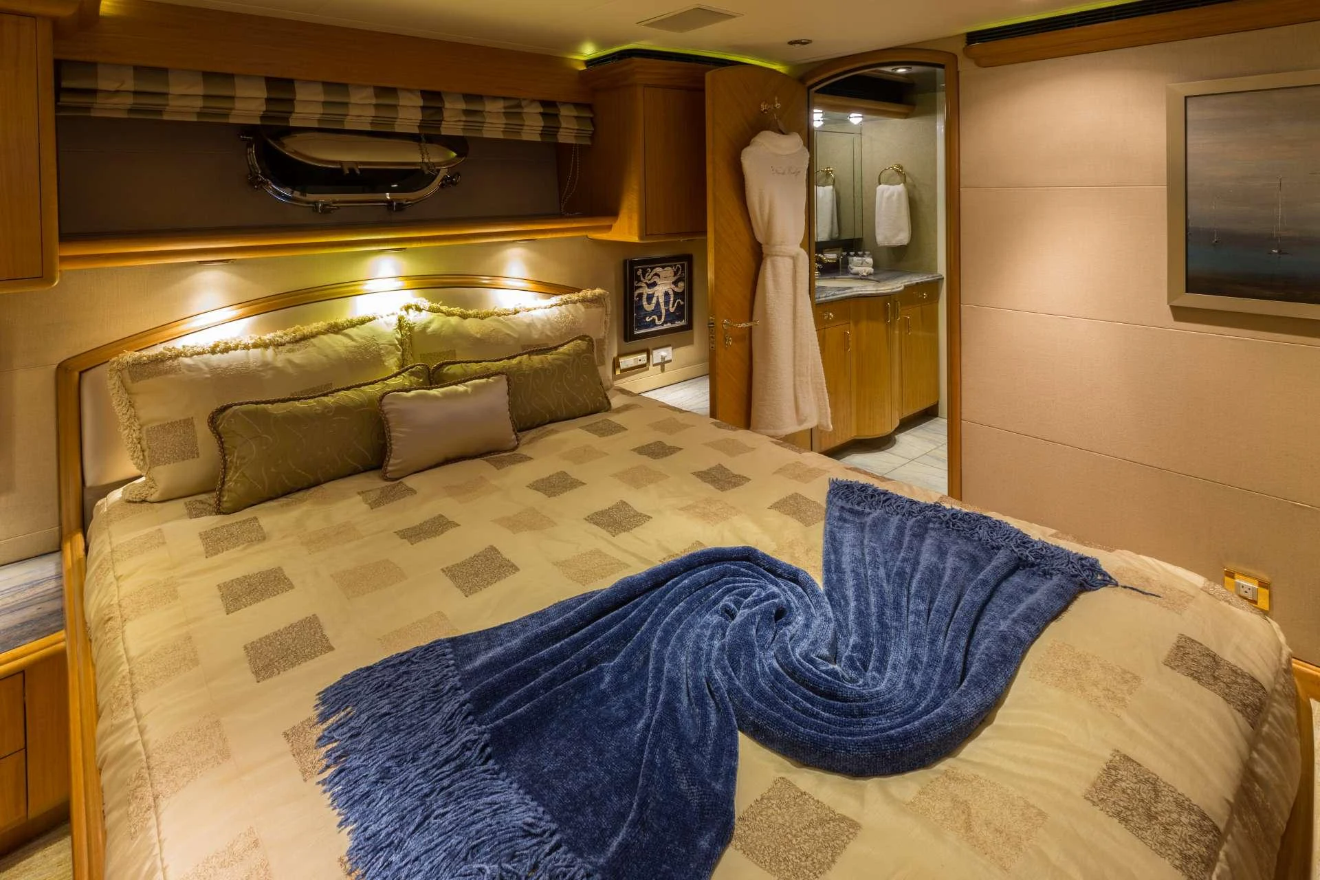 The master stateroom features a luxurious bed with elegant bedding and ambient lighting. aboard CHARLOTTE ANN Yacht for Charter
