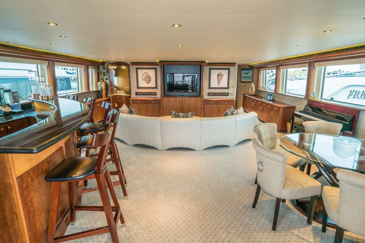 The salon features a spacious seating area with a large TV and elegant furnishings. aboard CHARLOTTE ANN Yacht for Charter