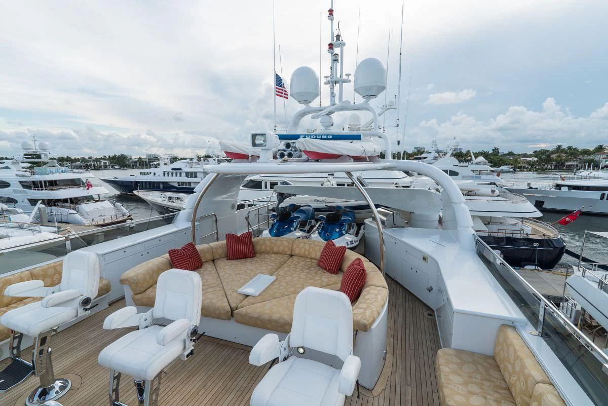 The flybridge offers a spacious seating area with plush cushions and a view of the marina. aboard CHARLOTTE ANN Yacht for Charter