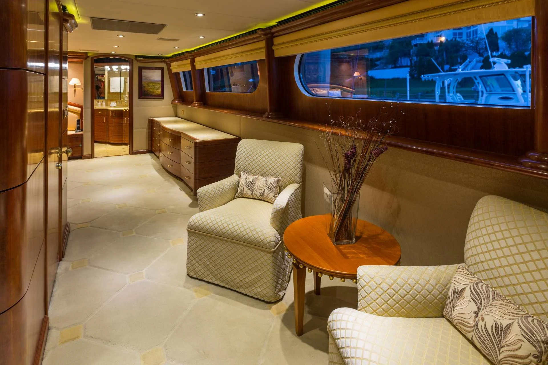 The yacht's interior features a cozy seating area with plush armchairs and elegant wooden furnishings. aboard CHARLOTTE ANN Yacht for Charter