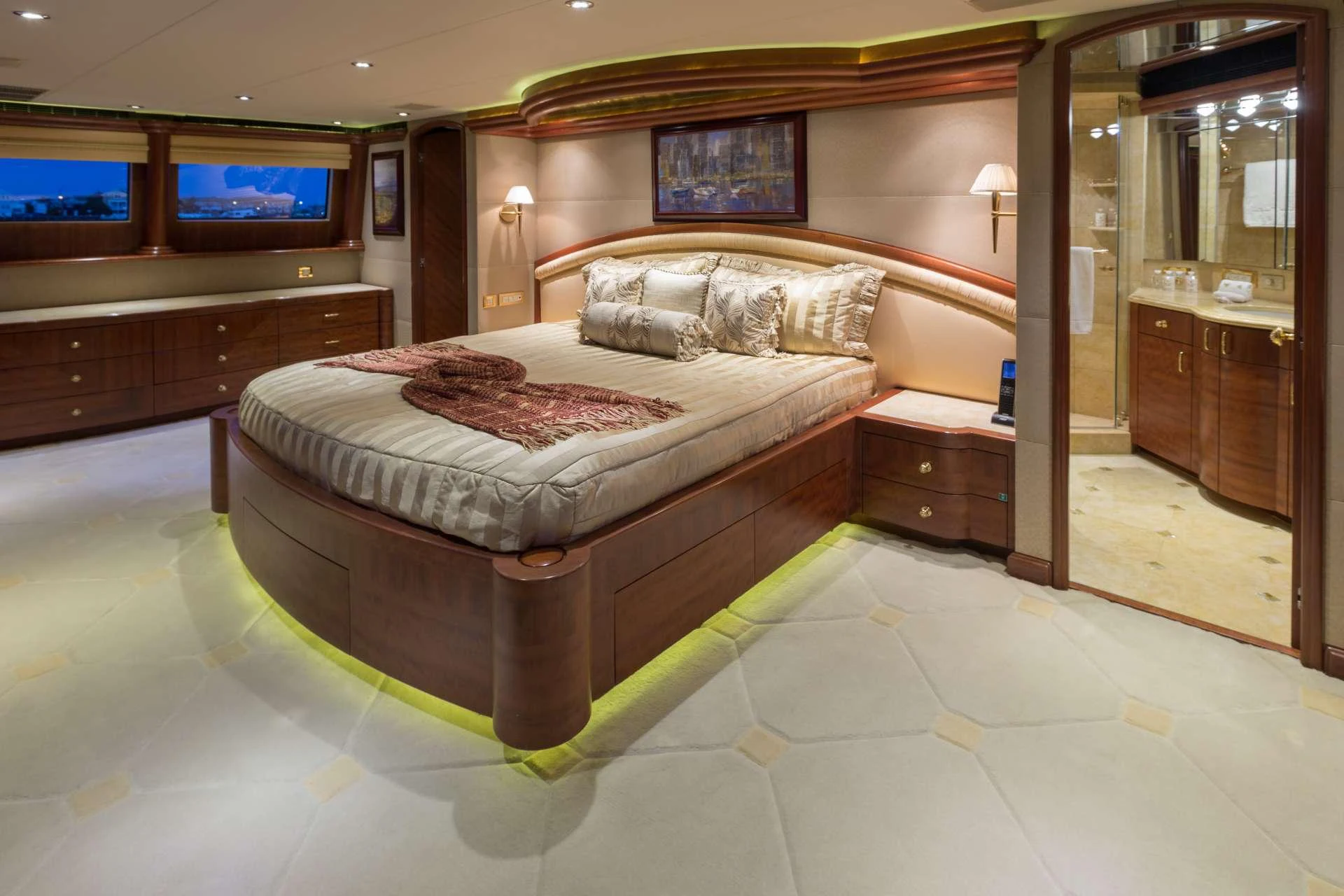 The master stateroom features a luxurious bed with elegant lighting and ample storage space. aboard CHARLOTTE ANN Yacht for Charter