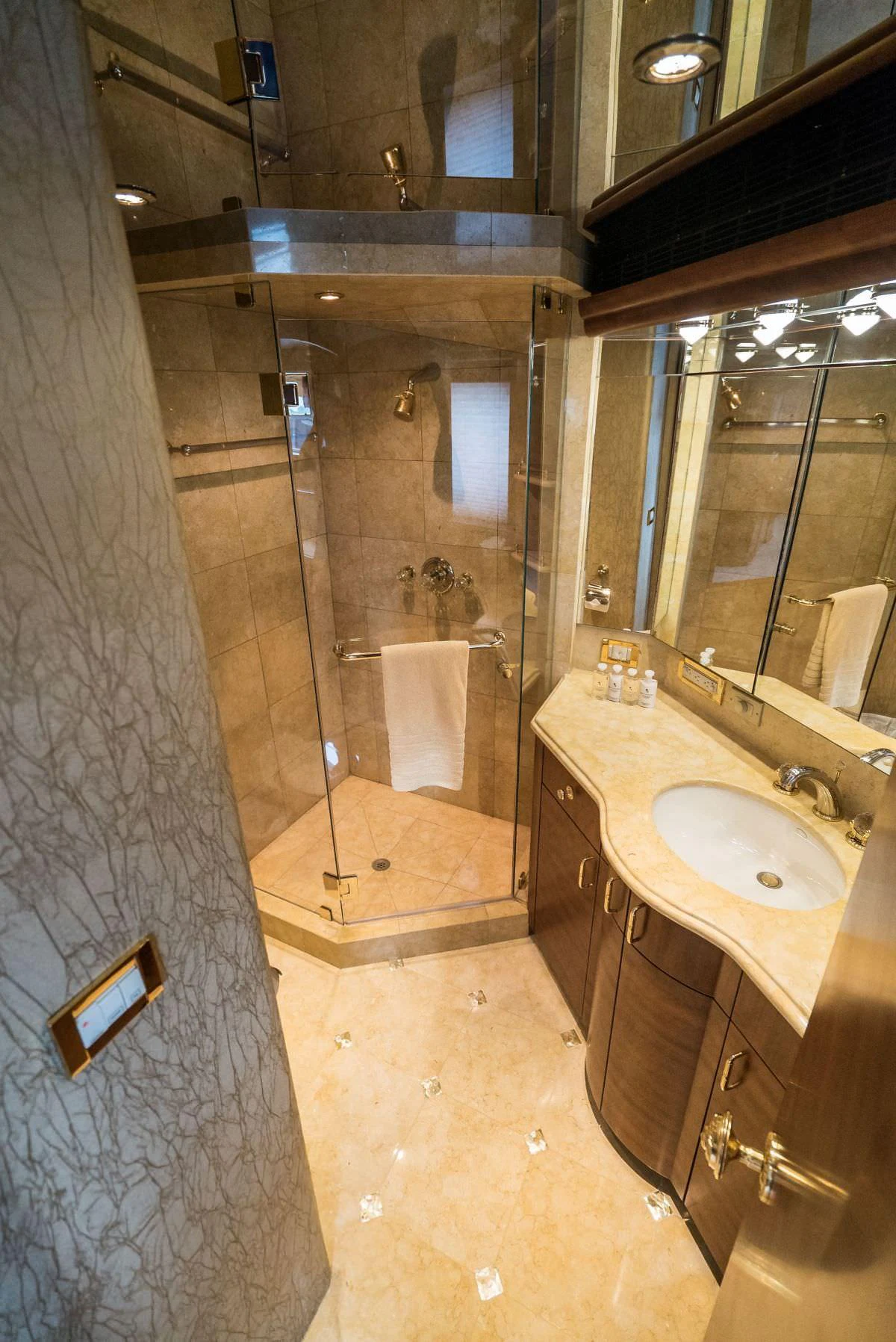 The yacht's bathroom features a glass-enclosed shower and a stylish vanity with a sink. aboard CHARLOTTE ANN Yacht for Charter