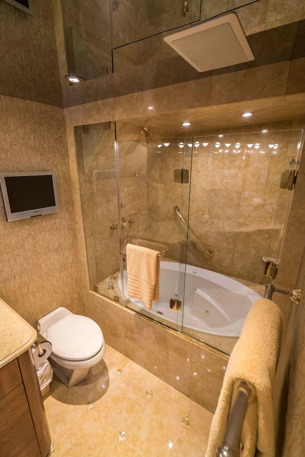 The yacht's bathroom features luxurious marble finishes and a spacious glass-enclosed shower. aboard CHARLOTTE ANN Yacht for Charter