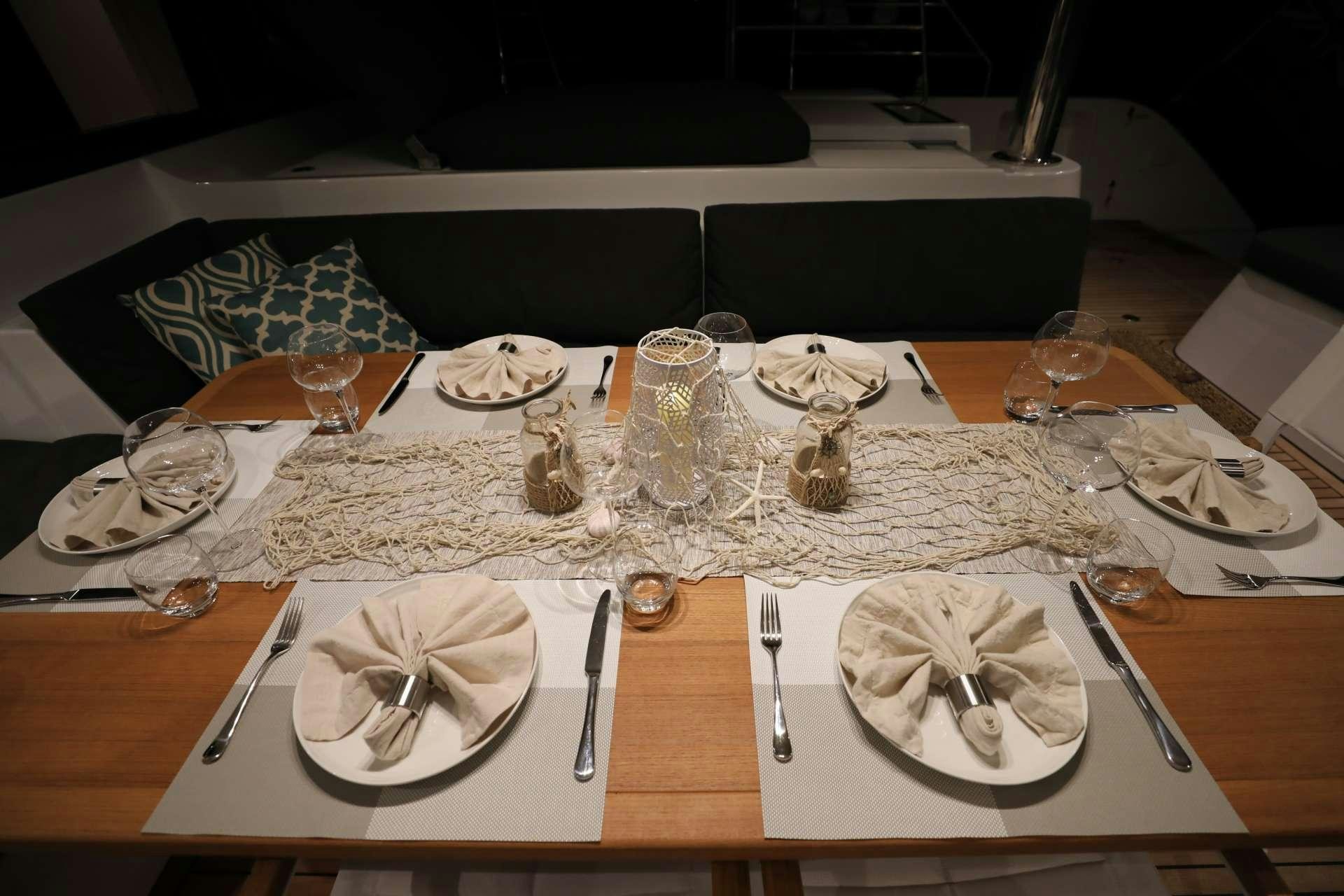 a table set with place settings aboard LADY FIONA Yacht for Charter