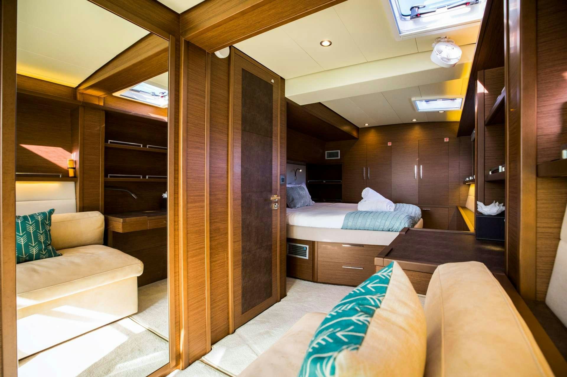 a room with a bed and a couch aboard LADY FIONA Yacht for Charter