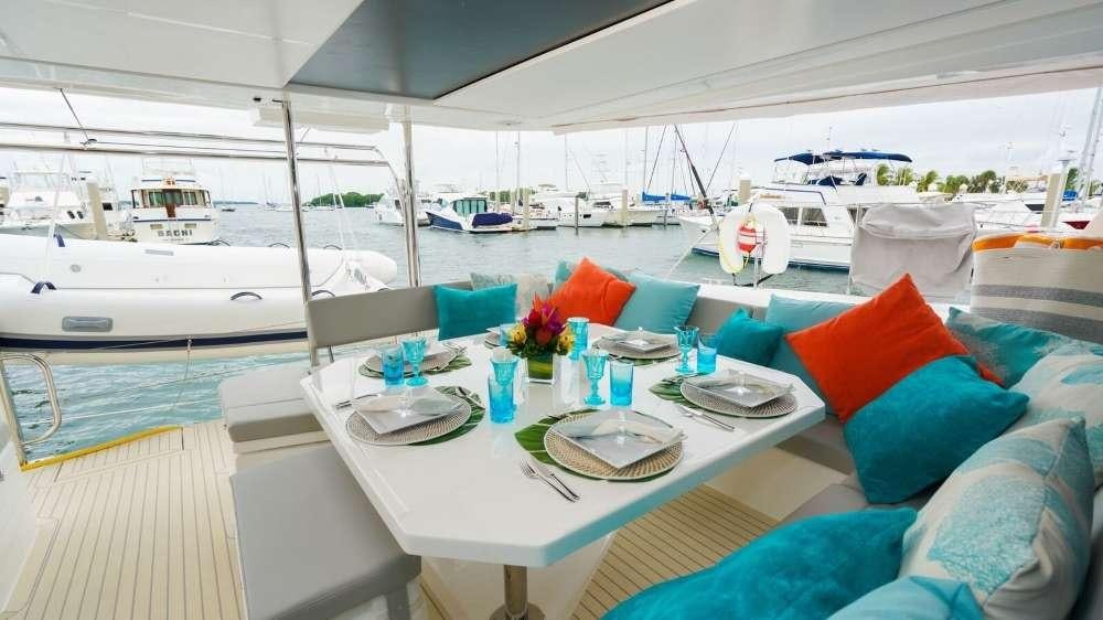 a table with plates and food on it aboard MOON BLOSSOM Yacht for Charter