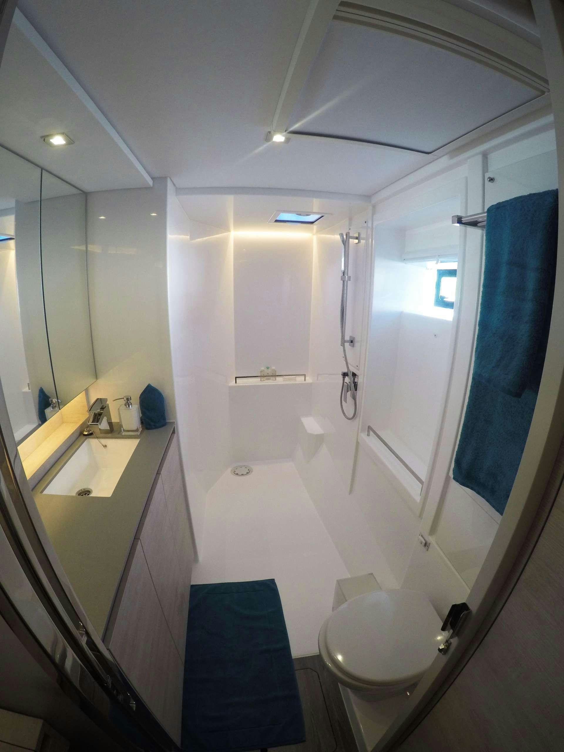 a bathroom with a shower and sink aboard MOON BLOSSOM Yacht for Charter
