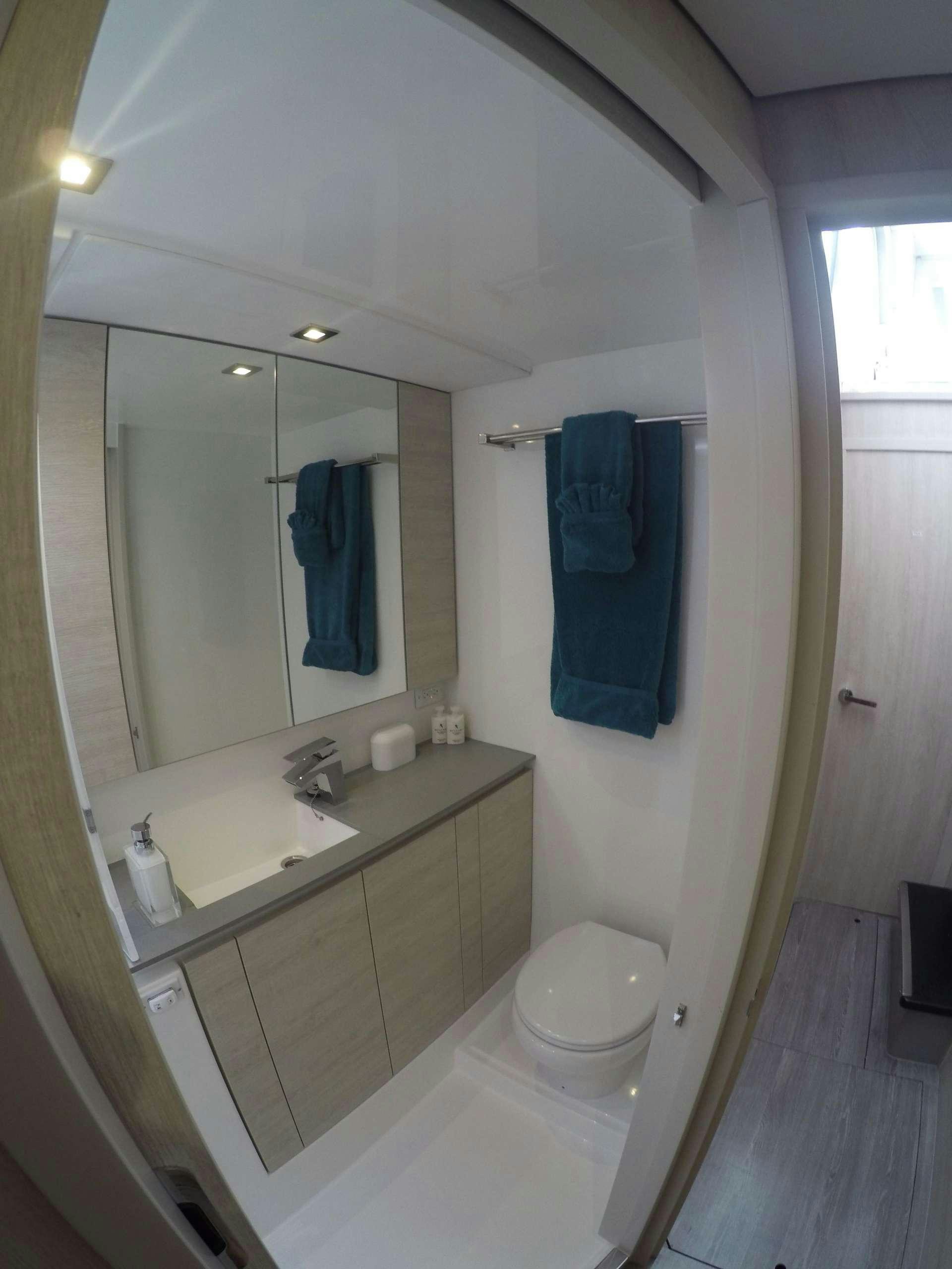 a bathroom with a sink and a mirror aboard MOON BLOSSOM Yacht for Charter