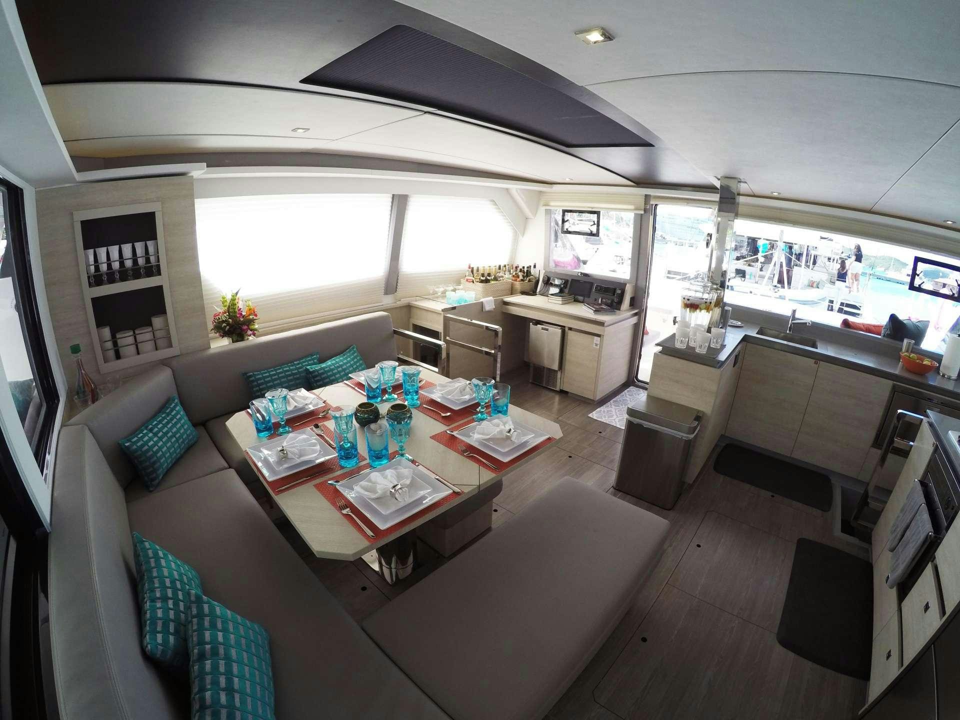 a living room with a table and chairs aboard MOON BLOSSOM Yacht for Charter