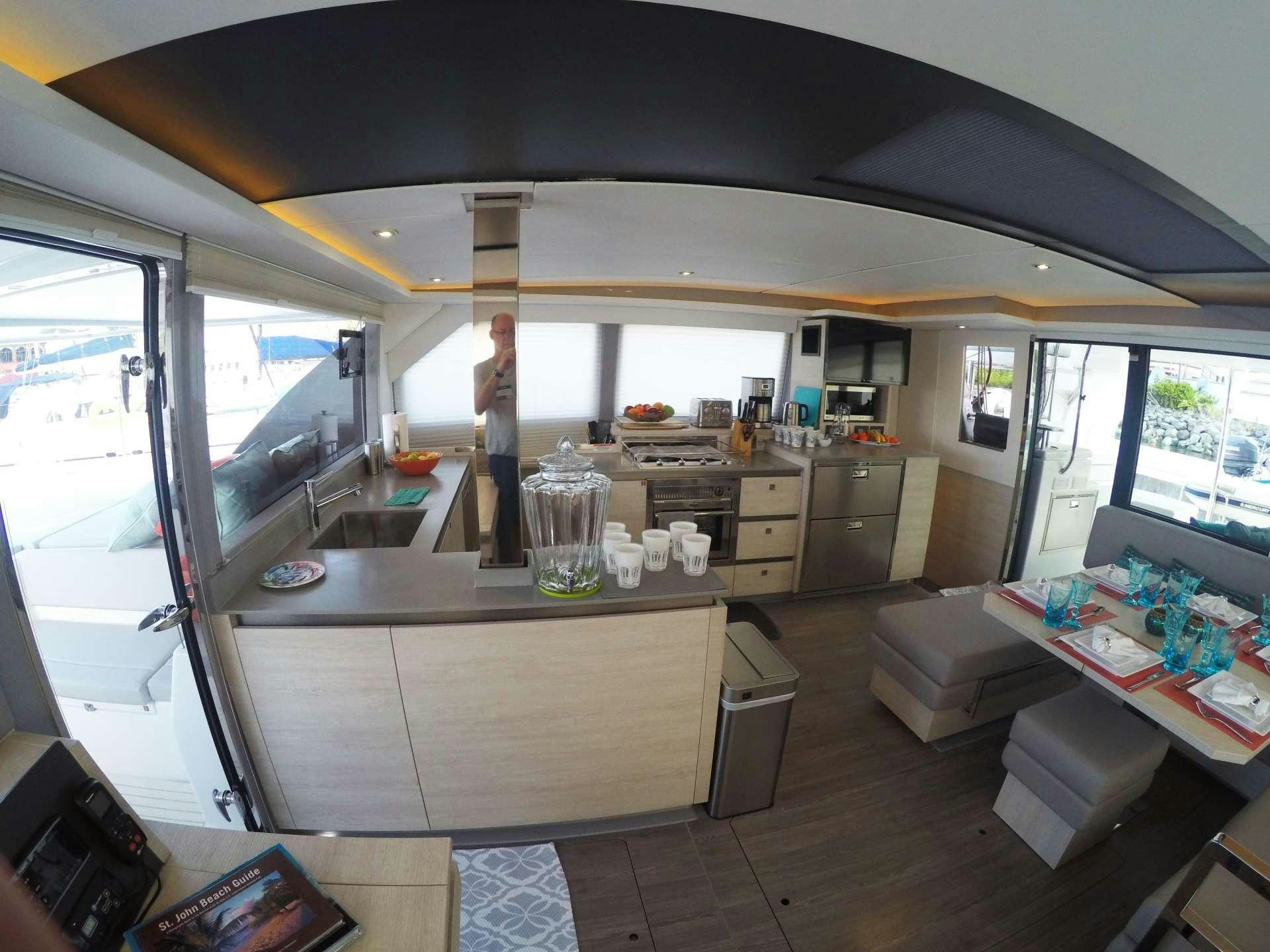 a person standing in a kitchen aboard MOON BLOSSOM Yacht for Charter