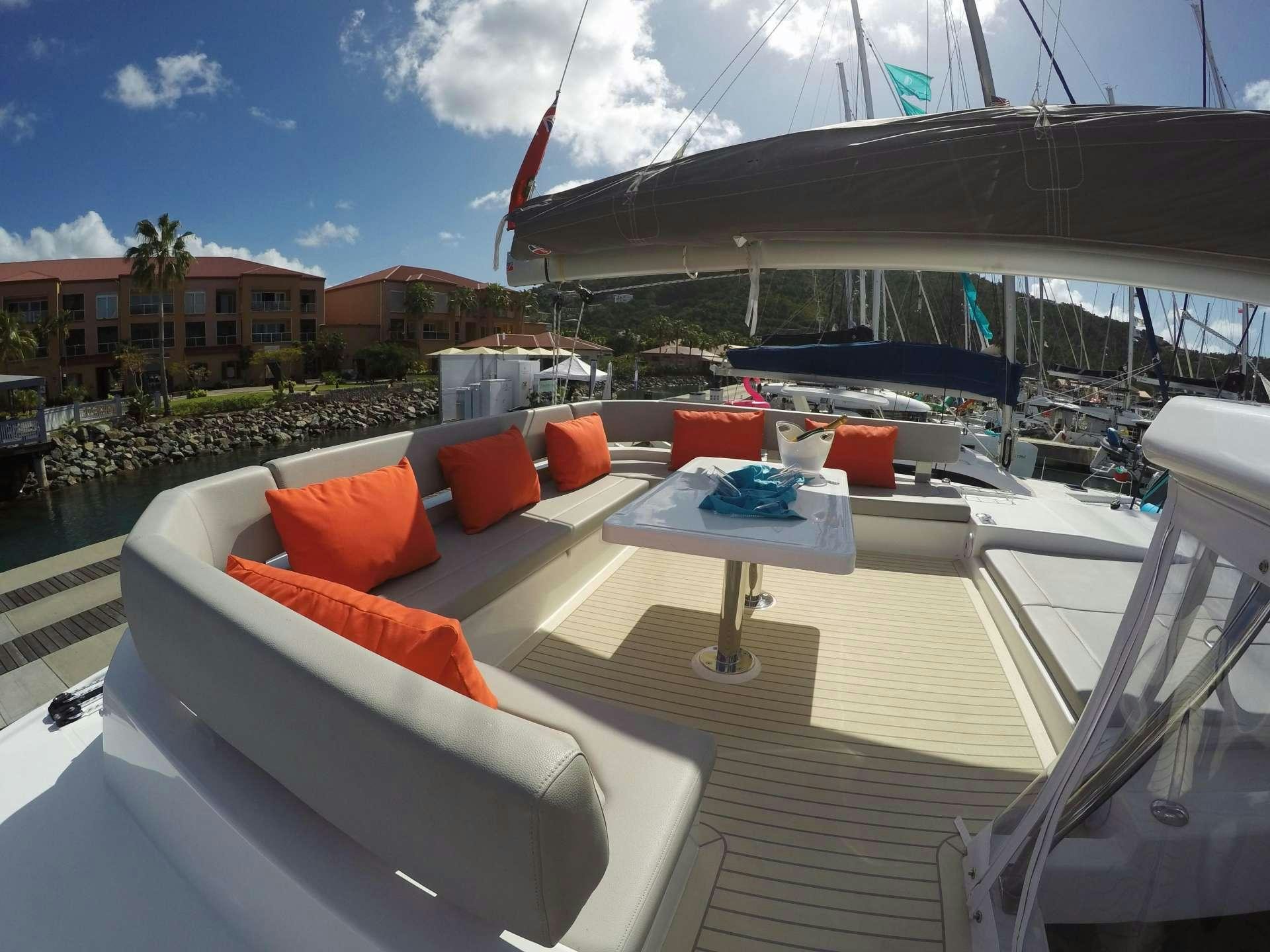 a deck with a table and chairs aboard MOON BLOSSOM Yacht for Charter