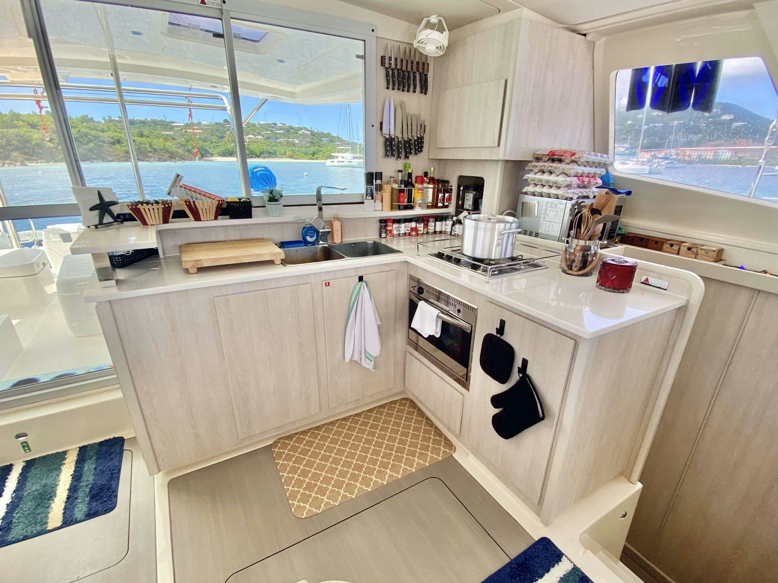 a kitchen with a sink and a window aboard LET'S PLAY TWO Yacht for Charter