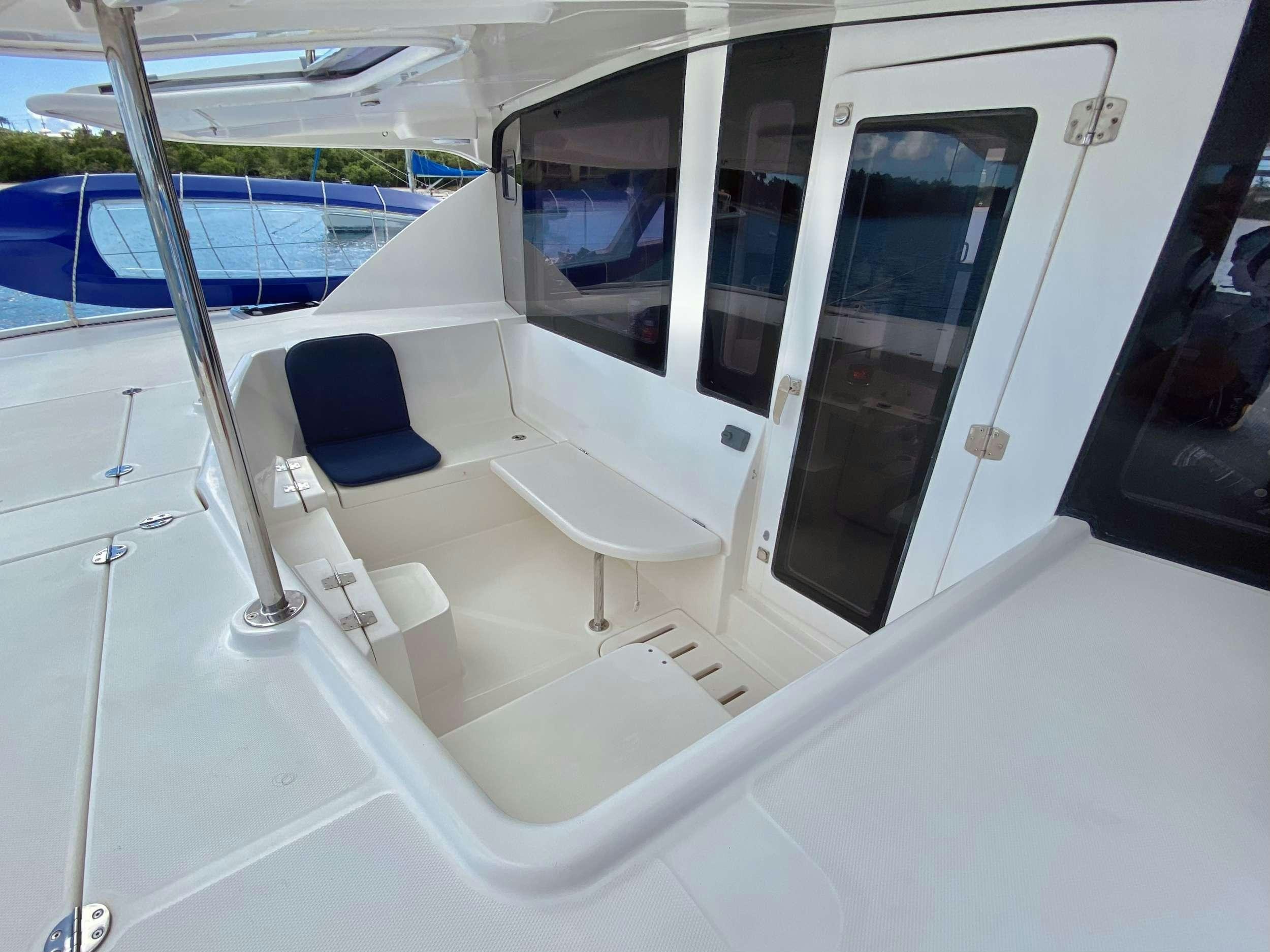 a room with a chair and a table aboard LET'S PLAY TWO Yacht for Charter