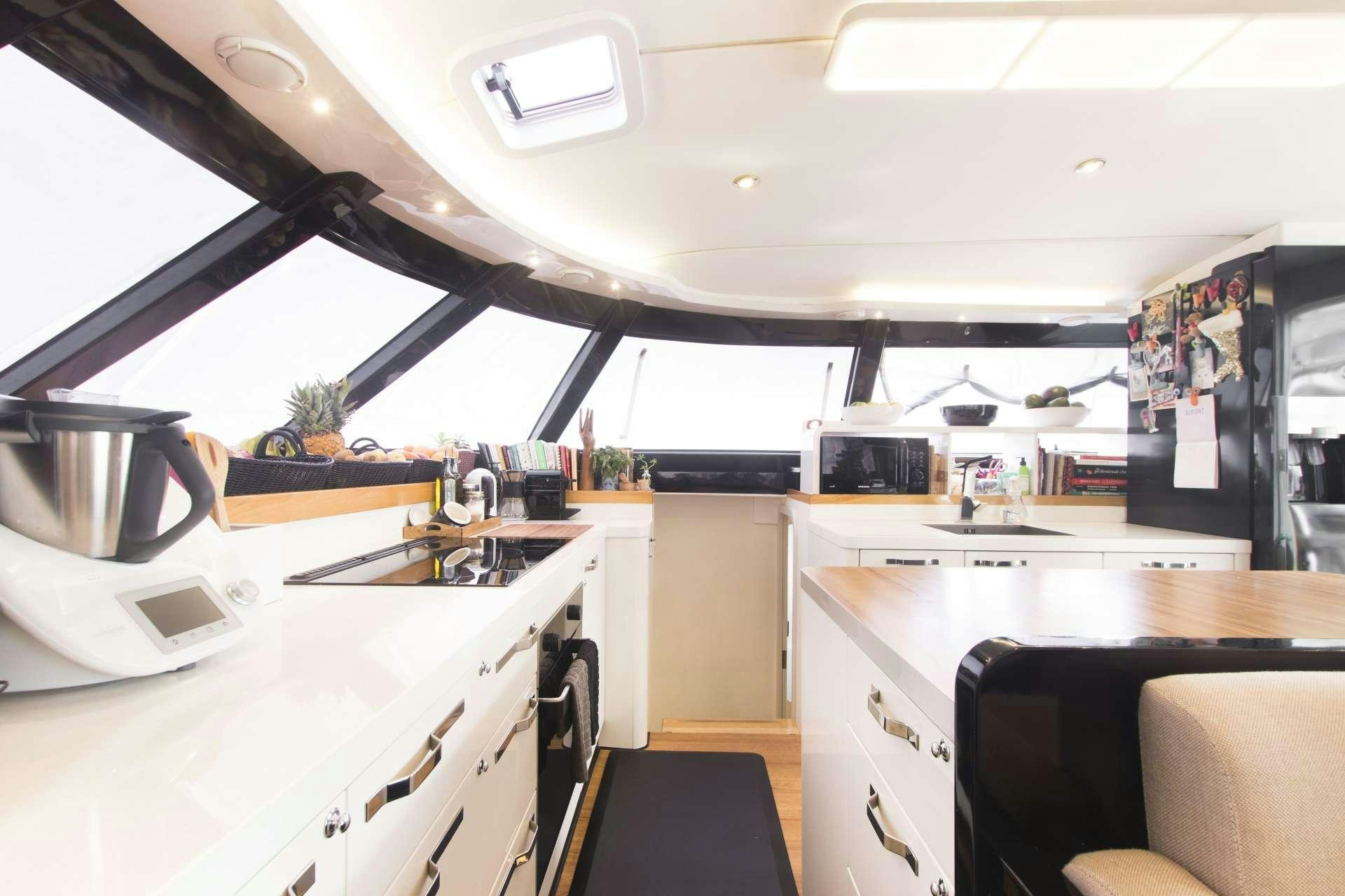 a kitchen with a large window aboard SANTA ANA Yacht for Charter
