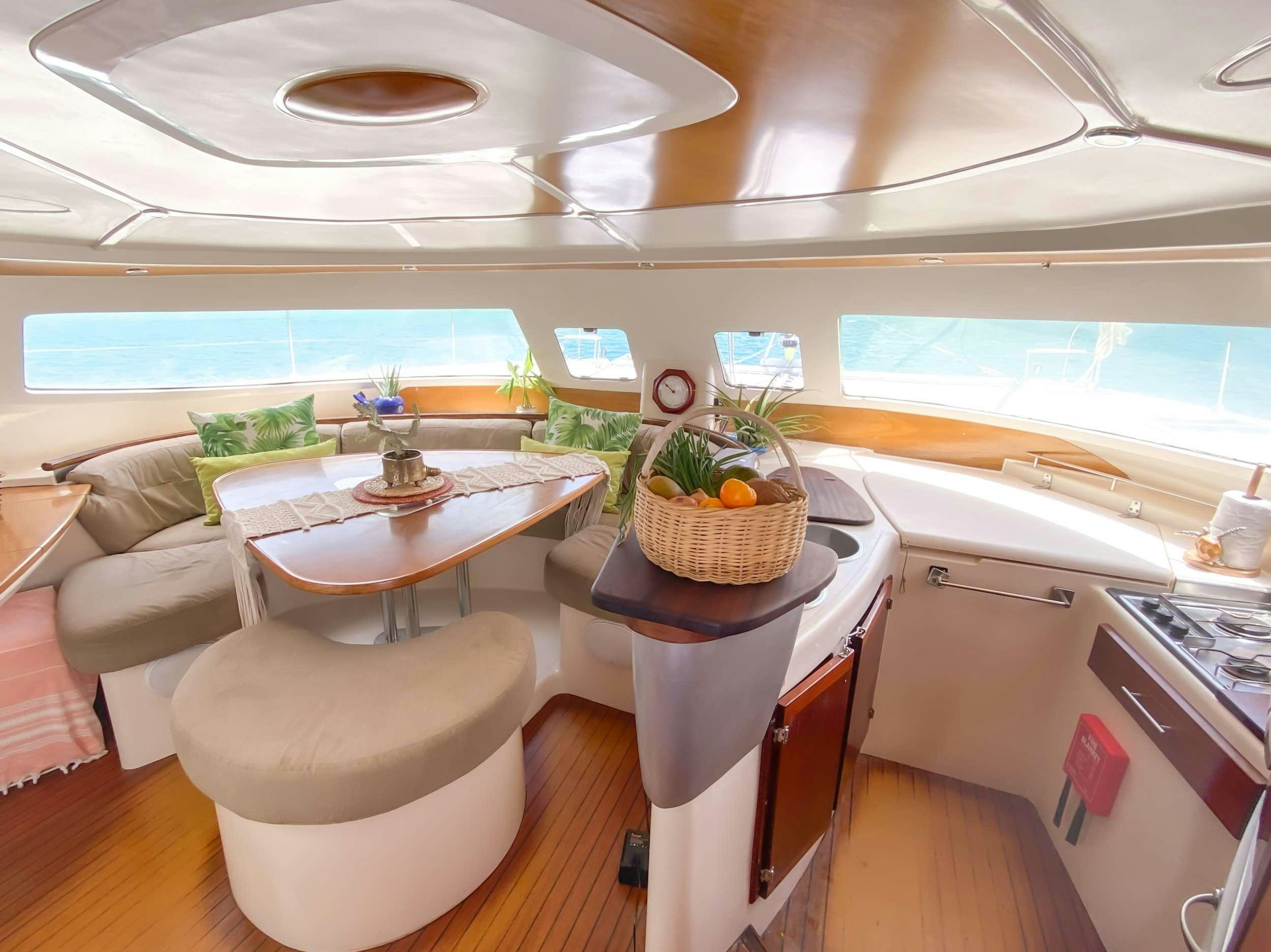 a kitchen with a table and chairs aboard Cataja Yacht for Charter