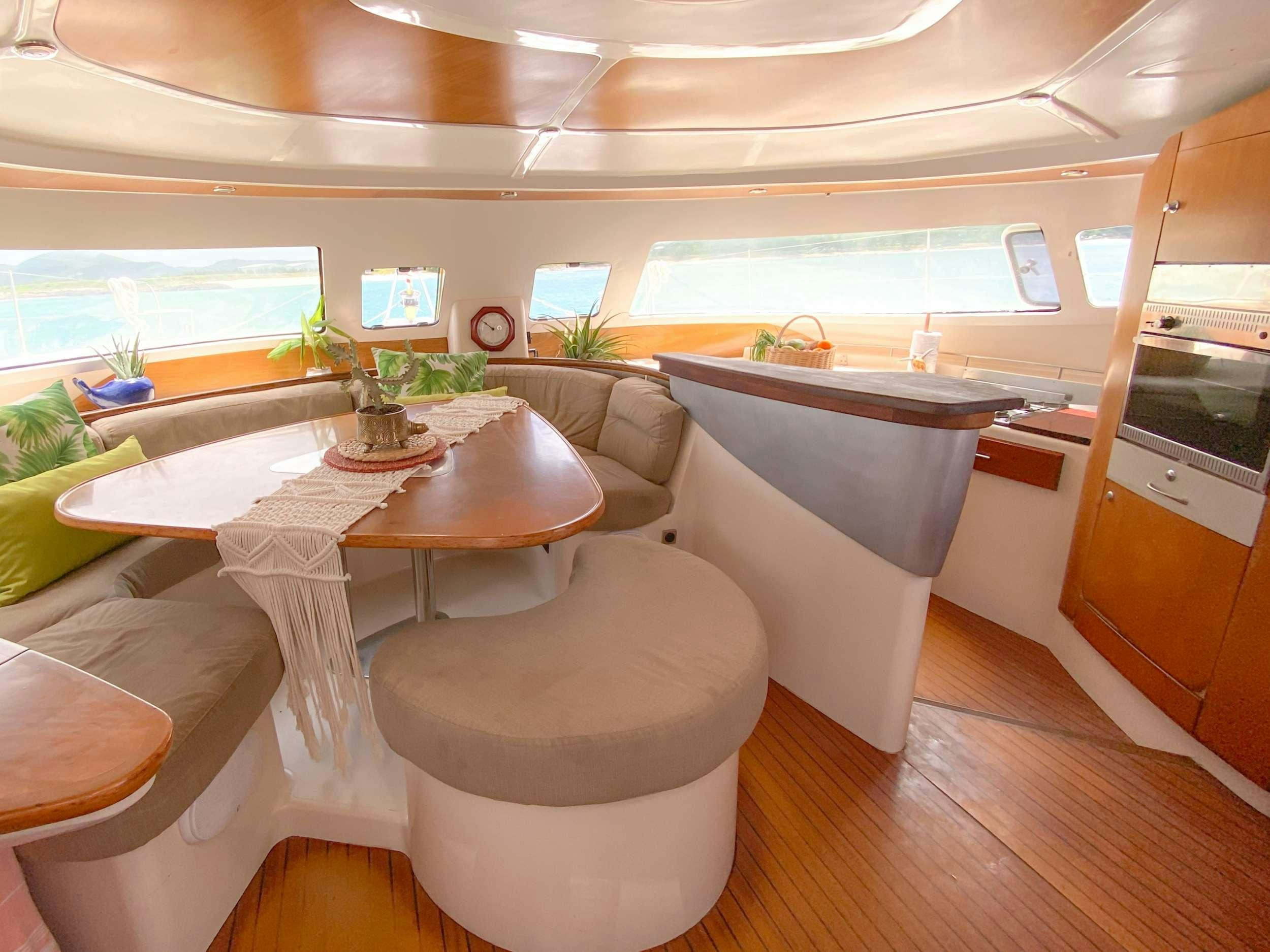 a room with a table and chairs aboard Cataja Yacht for Charter