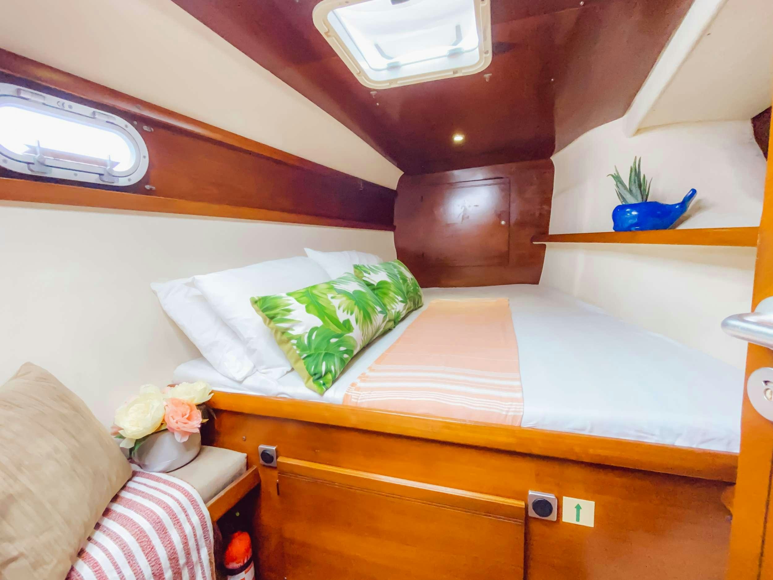 a bed with a shelf and a shelf with a pillow aboard Cataja Yacht for Charter