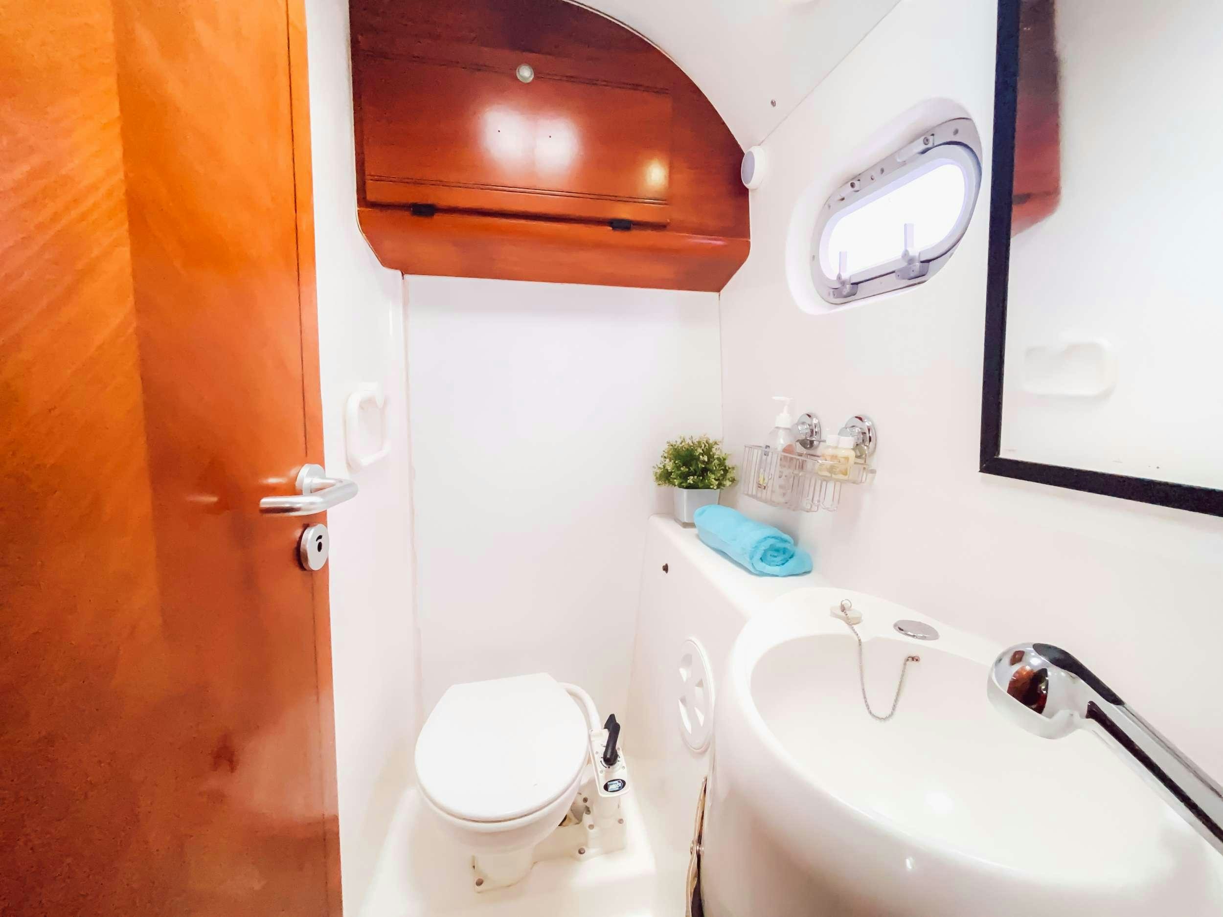 a bathroom with a toilet and sink aboard Cataja Yacht for Charter