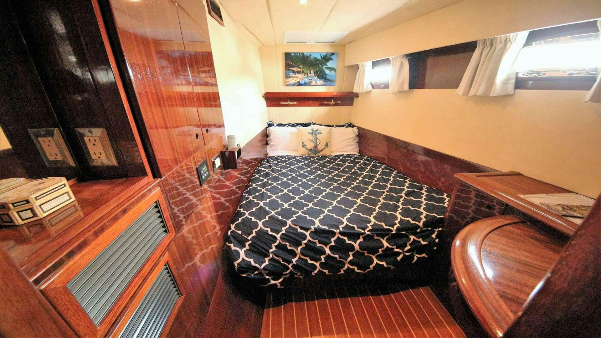 a room with a bed and a table aboard SOUTHERN PASSAGE Yacht for Charter