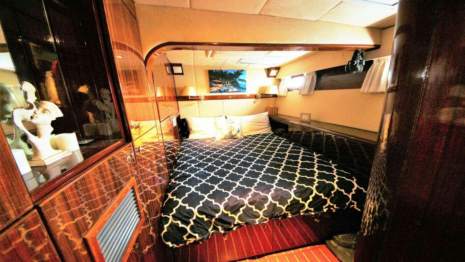 a bed with a checkered blanket aboard SOUTHERN PASSAGE Yacht for Charter