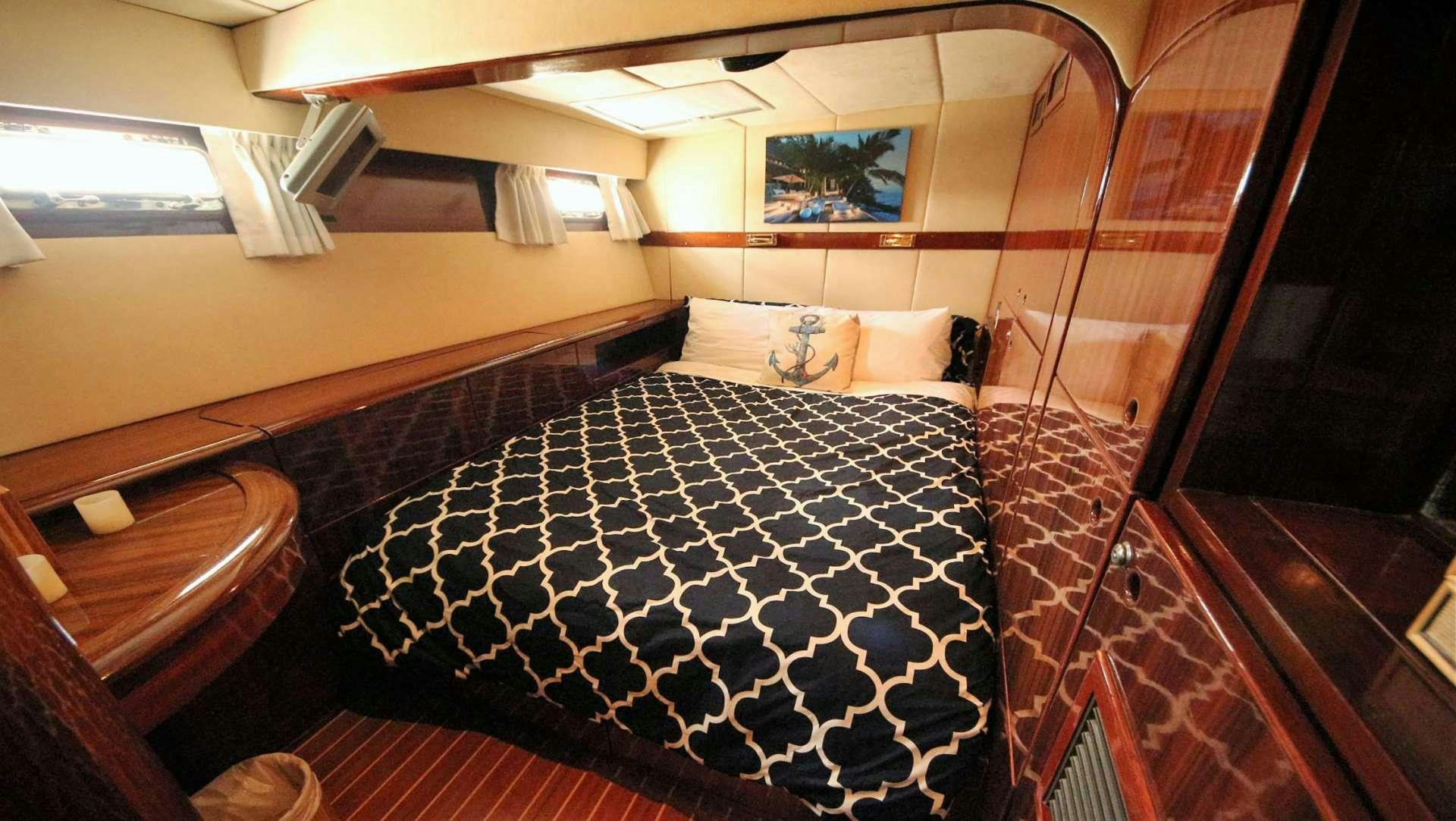 a bed with a black and white checkered blanket aboard SOUTHERN PASSAGE Yacht for Charter
