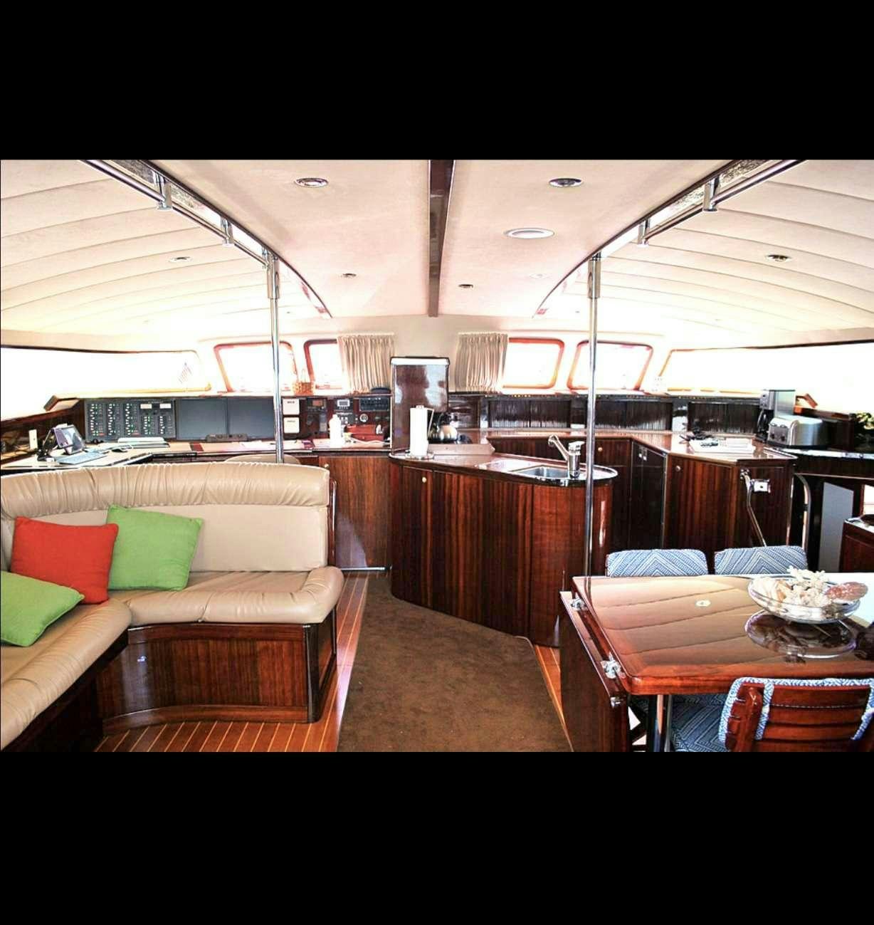 a large room with a couch and a table aboard SOUTHERN PASSAGE Yacht for Charter